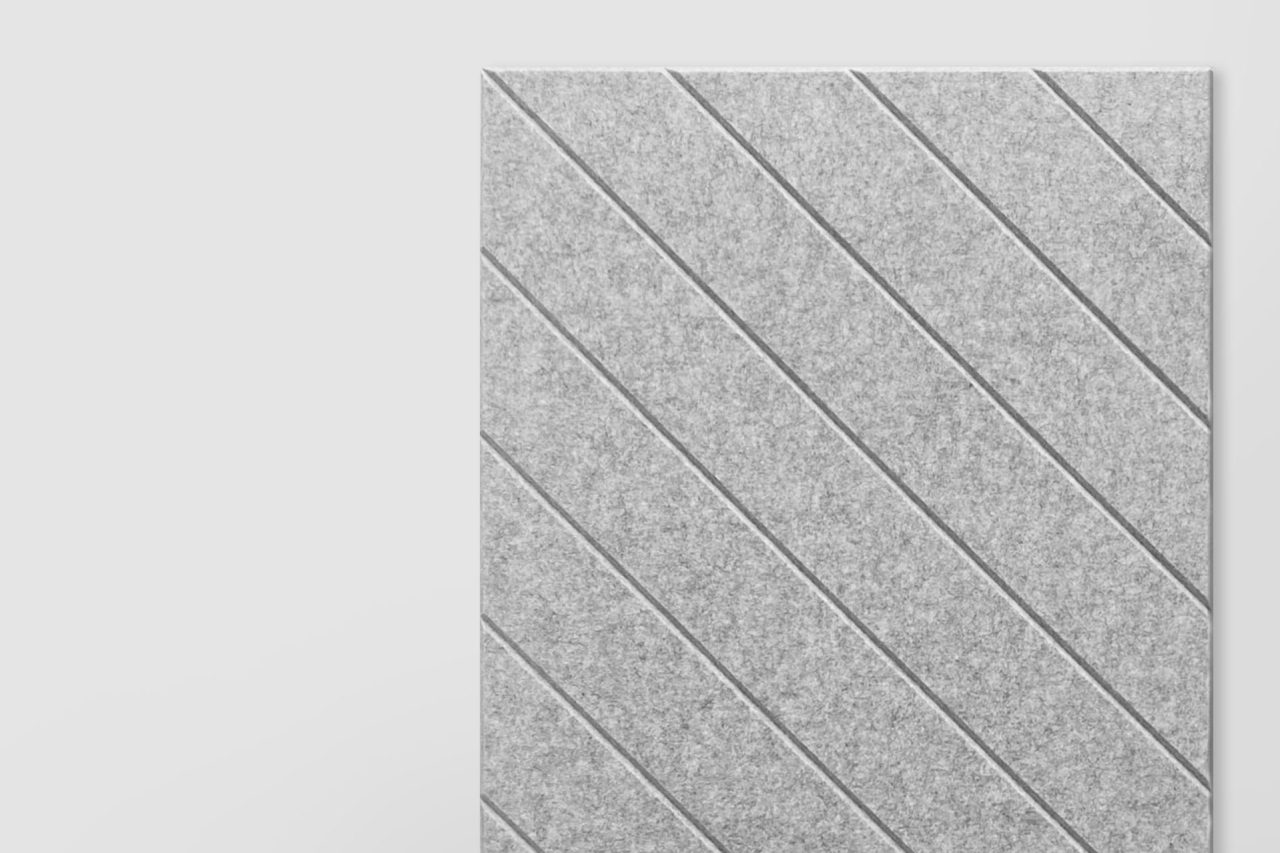 A rectangular gray polyester acoustic panel with diagonal grooves, positioned on the right side of a plain light background, showcases our Polyester Acoustic Panels offerings.