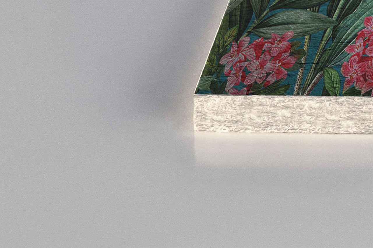 A close-up of the corner of a decorative object with a floral design, a textured white edge, and style inspired by Polyester Acoustic Panels Offerings on a smooth, light gray surface.
