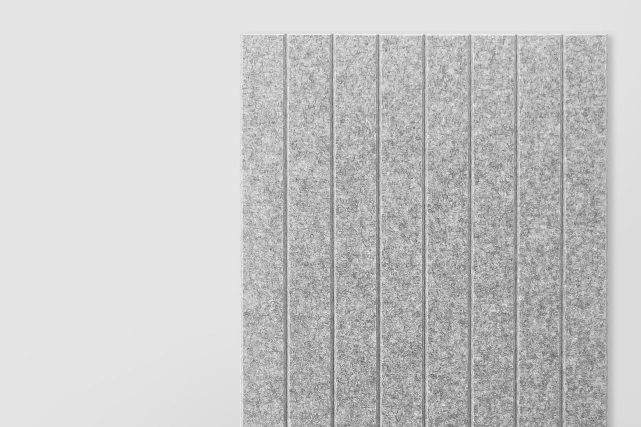 A section of gray textured panel with vertical grooves evenly spaced, positioned against a plain white background. This pattern creates a clean, modern look, reflecting the sleek style found in many Polyester Acoustic Panels Offerings.